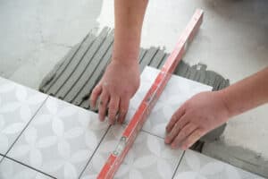 tiles being installed on floor by a contractor.