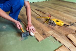 contractor installing new hardwood floors.